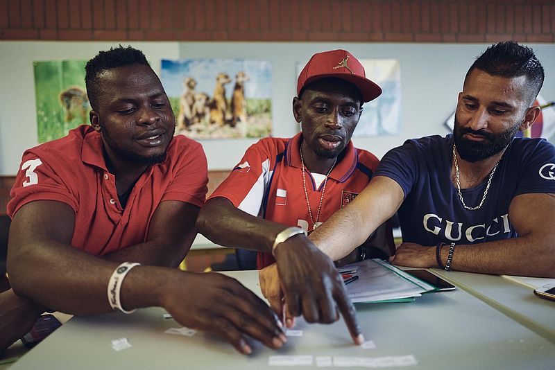 Drei junge Männer lernen gemeinsam